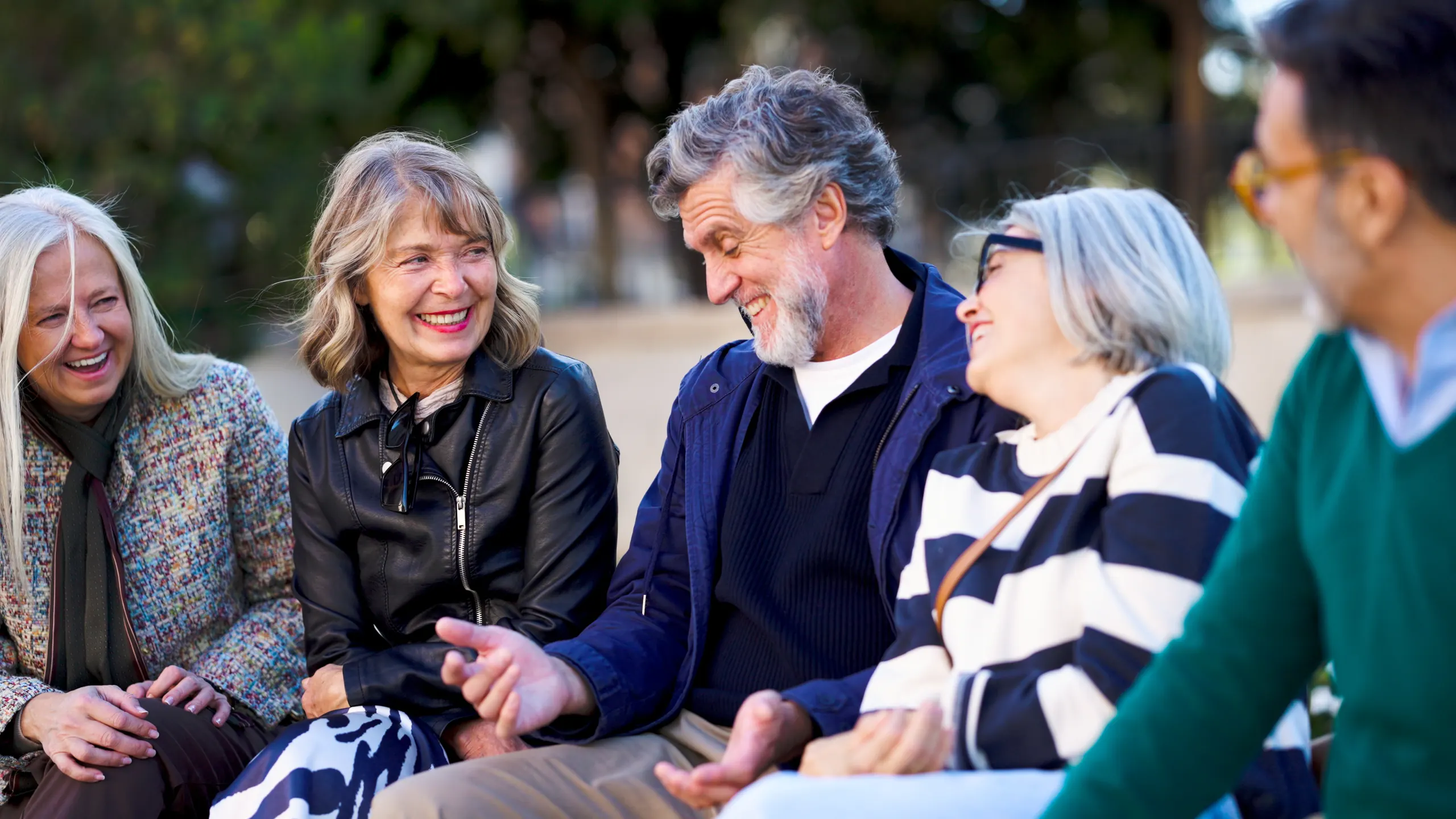 Senior friends laughing together outdoors